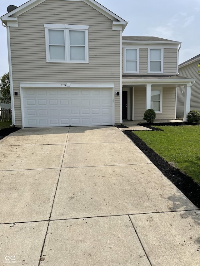 9701 W Constellation Dr, Pendleton, IN 46064 - traditional home featuring a garage, concrete driveway, a front yard, and covered porch