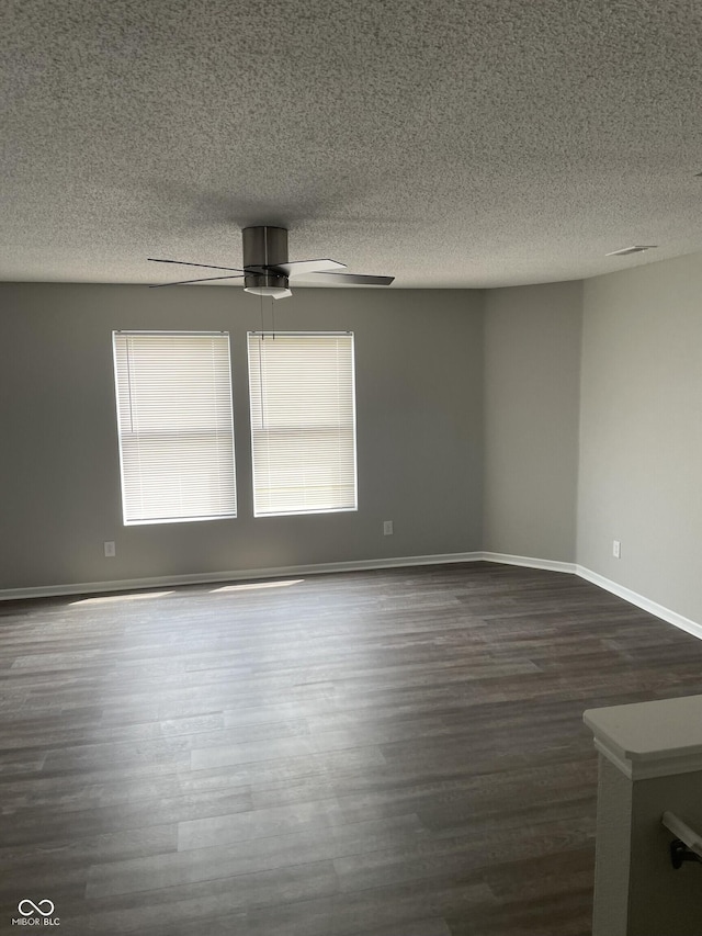 9701 W Constellation Dr, Pendleton, IN 46064 - spare room featuring dark wood-type flooring, a ceiling fan, and a textured ceiling