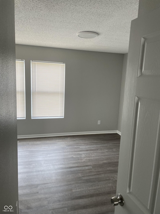 9701 W Constellation Dr, Pendleton, IN 46064 - unfurnished room featuring a textured ceiling and dark wood-style floors