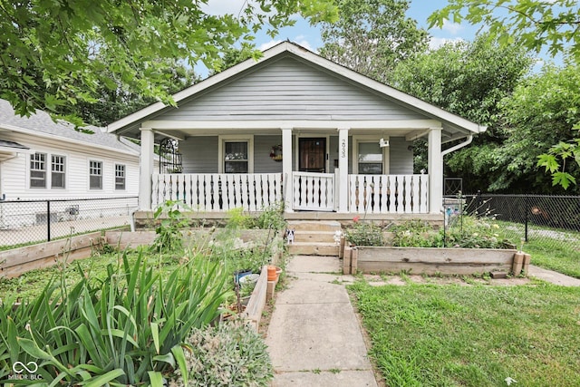 2933 S E St, Indianapolis, IN 46225 - bungalow-style home featuring a porch and a vegetable garden