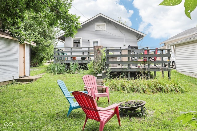 2933 S E St, Indianapolis, IN 46225 - view of green lawn with a fire pit, a wooden deck, and an outdoor structure