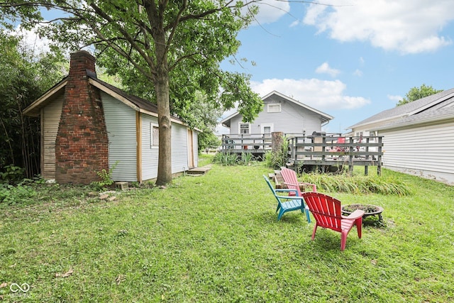 2933 S E St, Indianapolis, IN 46225 - view of grassy yard featuring a wooden deck and an outdoor fire pit