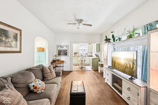 2933 S E St, Indianapolis, IN 46225 - living area with ceiling fan, wood-type flooring, and arched walkways