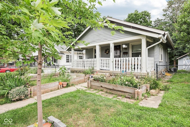 2933 S E St, Indianapolis, IN 46225 - bungalow-style house featuring covered porch and a vegetable garden