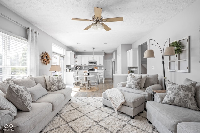 2025 W Morse Dr, Cicero, IN 46034 - living room featuring light wood-style flooring, a ceiling fan, and a textured ceiling