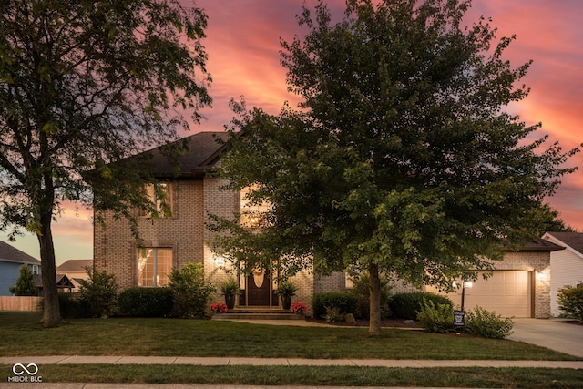 2025 W Morse Dr, Cicero, IN 46034 - view of property hidden behind natural elements with brick siding, driveway, a front yard, and a garage