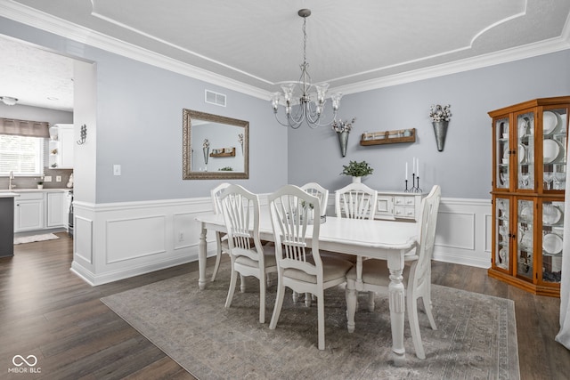 2025 W Morse Dr, Cicero, IN 46034 - dining room with a chandelier, dark wood-type flooring, crown molding, wainscoting, and a decorative wall