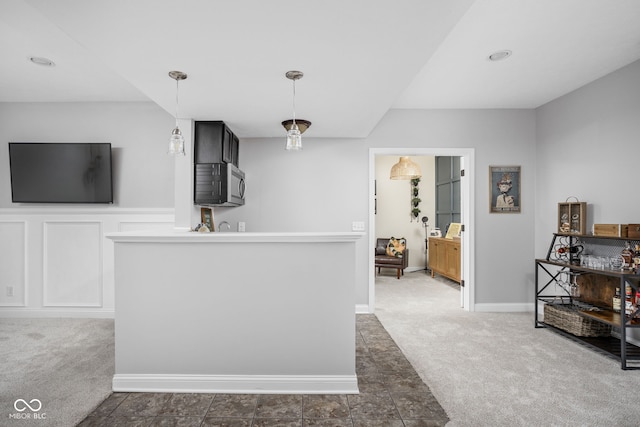 2025 W Morse Dr, Cicero, IN 46034 - kitchen with stainless steel microwave, dark colored carpet, and decorative light fixtures