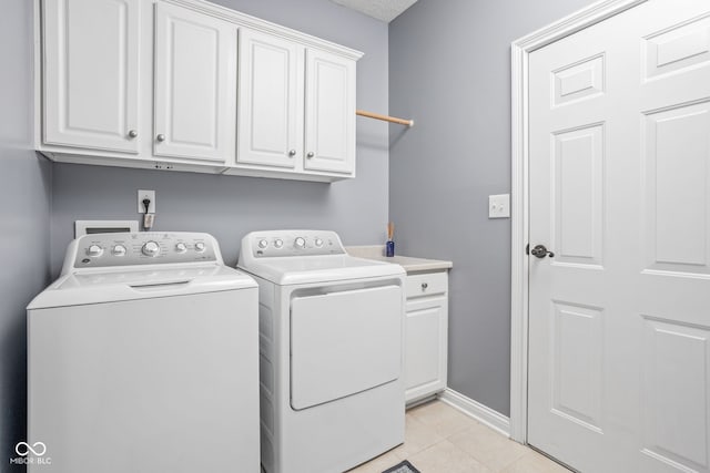 2025 W Morse Dr, Cicero, IN 46034 - washroom featuring washing machine and clothes dryer, cabinet space, and light tile patterned floors