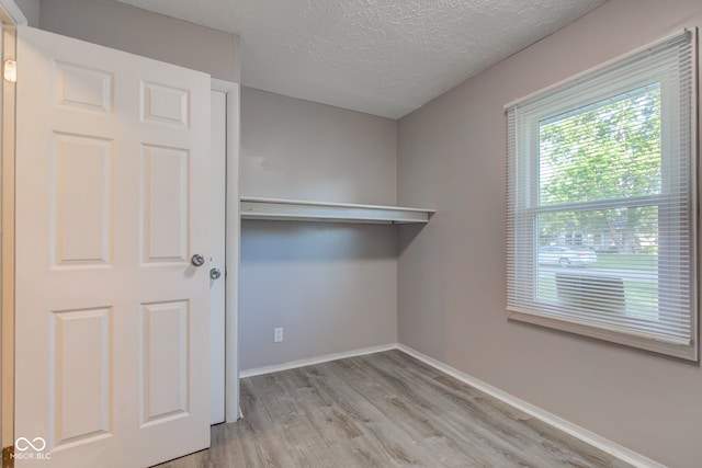 1453 Churchill Rd, Franklin, IN 46131 - laundry room featuring light wood-style floors and a textured ceiling