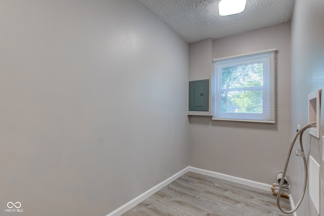 1453 Churchill Rd, Franklin, IN 46131 - washroom featuring electric panel, light wood-type flooring, and a textured ceiling