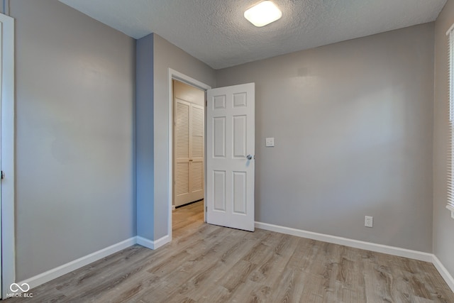 1453 Churchill Rd, Franklin, IN 46131 - empty room featuring light wood finished floors and a textured ceiling