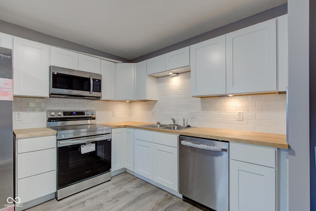 1453 Churchill Rd, Franklin, IN 46131 - kitchen with stainless steel appliances, wooden counters, light wood-style floors, and backsplash