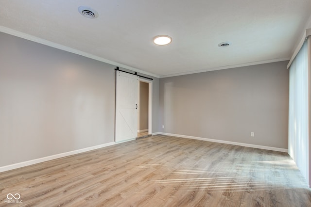 1453 Churchill Rd, Franklin, IN 46131 - spare room with a barn door, crown molding, and light wood-type flooring