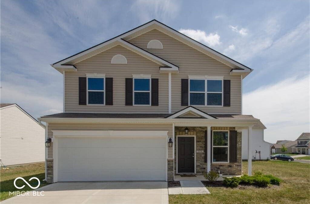 3371 Firethorn Dr, Whitestown, IN 46075 - view of front of property with driveway, stone siding, and a garage