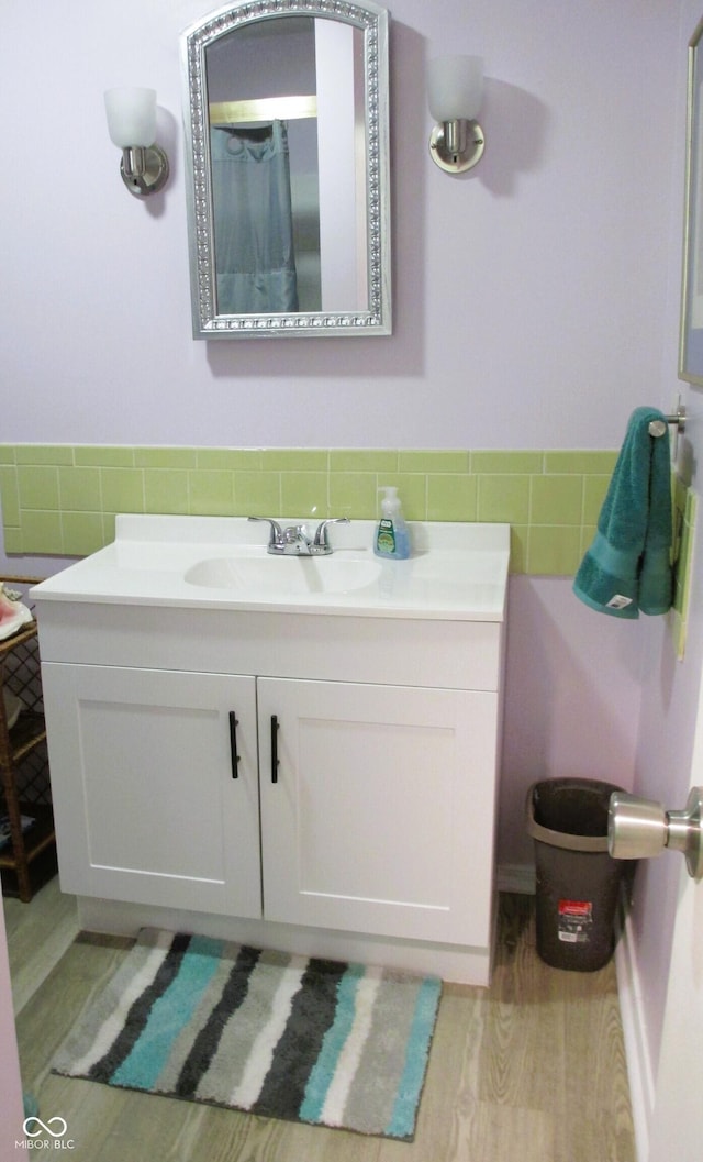 6808 Summer Time Dr, Indianapolis, IN 46226 - bathroom featuring tile walls, vanity, wood finished floors, and wainscoting