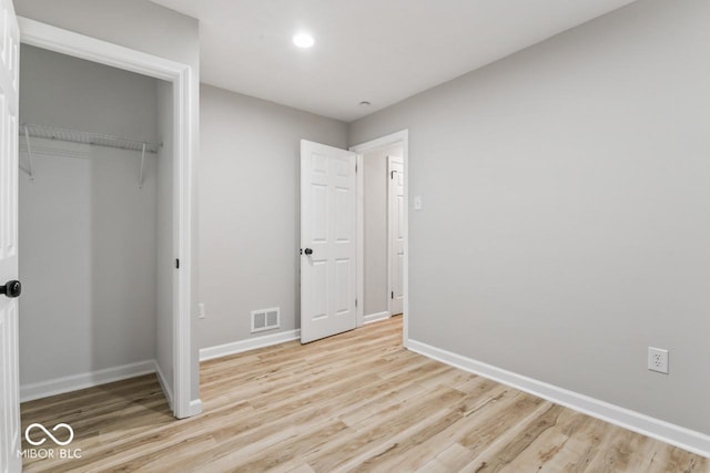 3369 N Chester Ave, Indianapolis, IN 46218 - unfurnished bedroom featuring light wood-style floors, recessed lighting, and a closet