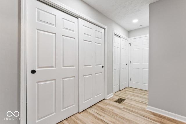 3369 N Chester Ave, Indianapolis, IN 46218 - corridor with light wood-type flooring and a textured ceiling