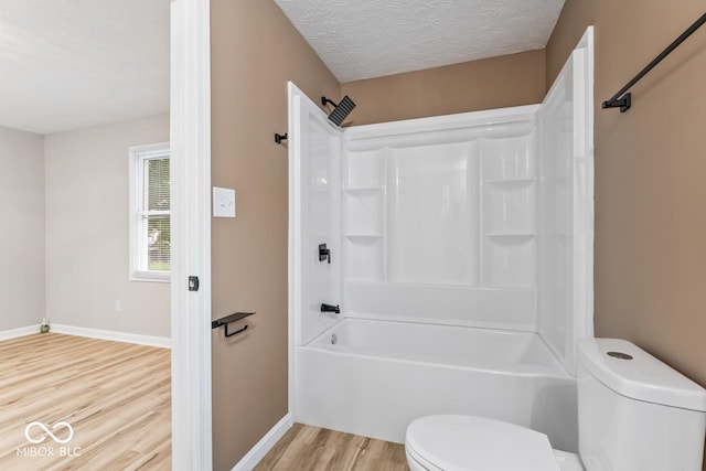 3369 N Chester Ave, Indianapolis, IN 46218 - bathroom featuring wood finished floors, tub / shower combination, and a textured ceiling