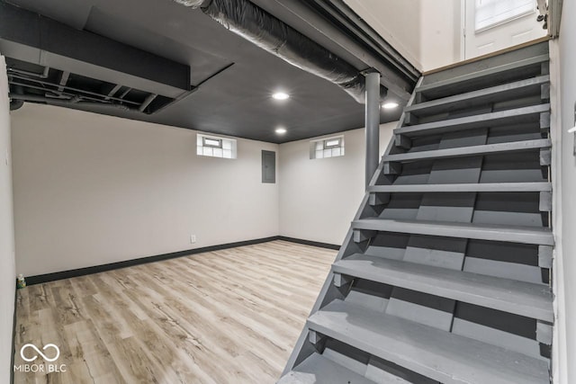 3369 N Chester Ave, Indianapolis, IN 46218 - basement featuring wood finished floors, electric panel, and recessed lighting