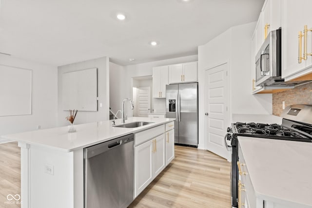 7239 Governors Row, Avon, IN 46123 - kitchen with appliances with stainless steel finishes, a center island with sink, white cabinets, light wood finished floors, and recessed lighting