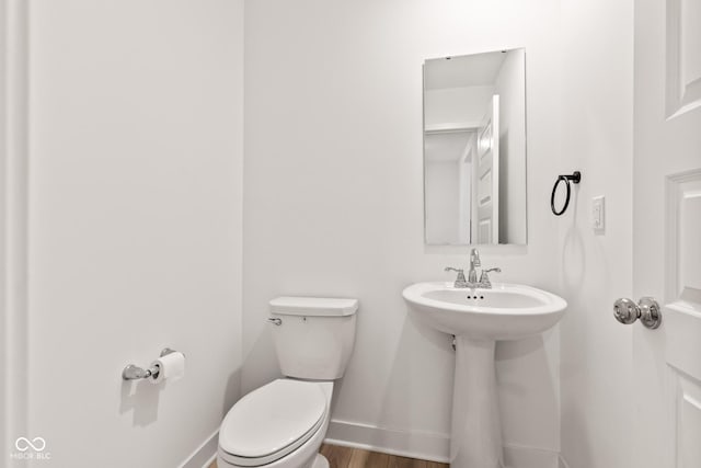 7239 Governors Row, Avon, IN 46123 - half bathroom featuring toilet and wood finished floors