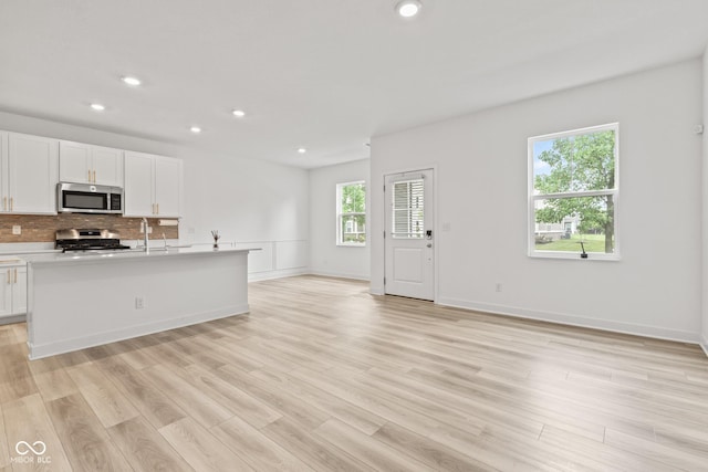 7239 Governors Row, Avon, IN 46123 - kitchen with appliances with stainless steel finishes, recessed lighting, decorative backsplash, white cabinetry, and open floor plan