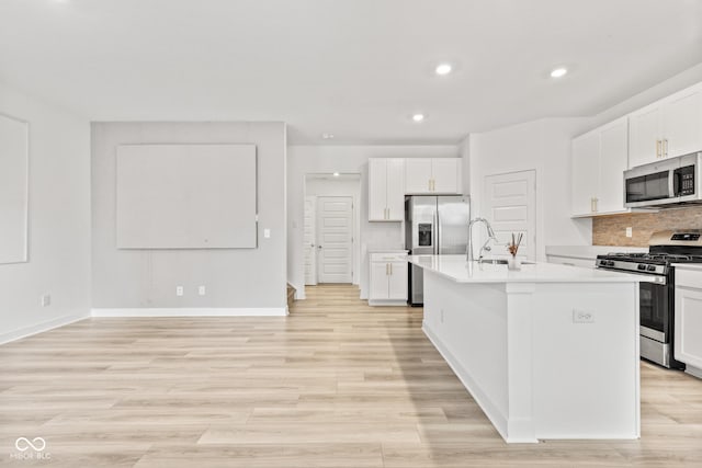 7239 Governors Row, Avon, IN 46123 - kitchen with stainless steel appliances, light countertops, a kitchen island with sink, white cabinetry, and backsplash