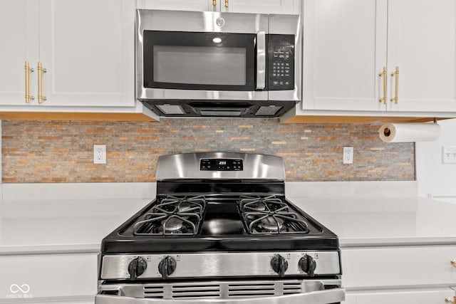 7239 Governors Row, Avon, IN 46123 - kitchen with appliances with stainless steel finishes, light countertops, white cabinets, and backsplash