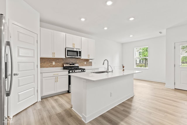 7239 Governors Row, Avon, IN 46123 - kitchen featuring appliances with stainless steel finishes, light wood-style floors, white cabinets, light countertops, and backsplash