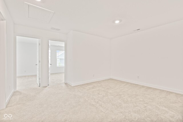 7239 Governors Row, Avon, IN 46123 - empty room featuring light colored carpet, recessed lighting, and attic access
