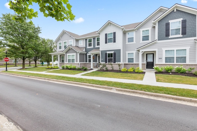 7239 Governors Row, Avon, IN 46123 - townhome / multi-family property with a front yard and brick siding