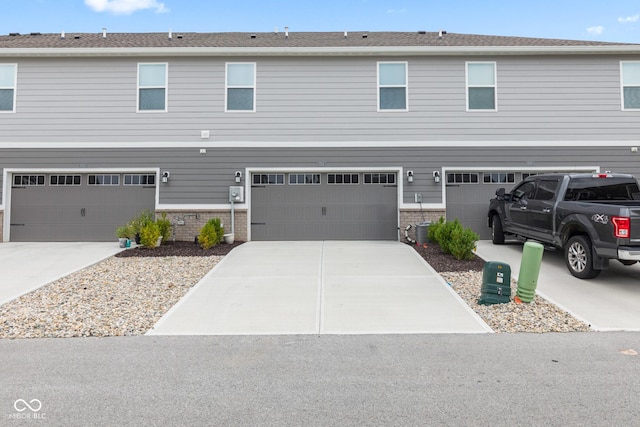 7239 Governors Row, Avon, IN 46123 - view of front of property with an attached garage, driveway, and brick siding
