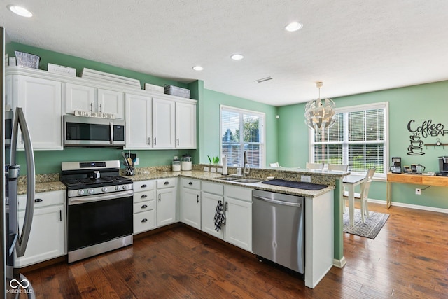 16745 Del Mar Way, Westfield, IN 46074 - kitchen with stainless steel appliances, a peninsula, white cabinets, and recessed lighting