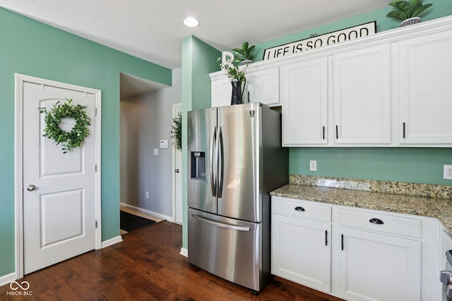 16745 Del Mar Way, Westfield, IN 46074 - kitchen with stainless steel fridge, white cabinetry, dark wood-style floors, light stone countertops, and recessed lighting
