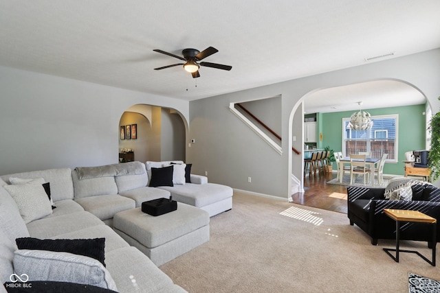 16745 Del Mar Way, Westfield, IN 46074 - carpeted living area featuring arched walkways, a chandelier, and a ceiling fan