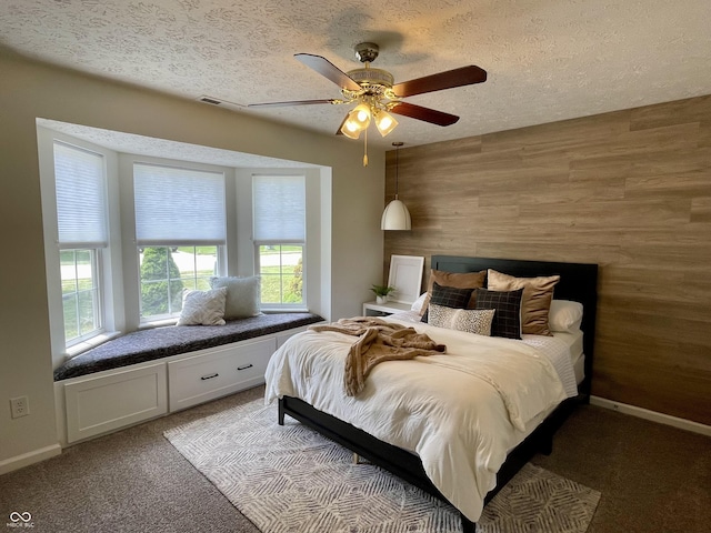 8202 Stonelick Dr, Avon, IN 46123 - bedroom featuring carpet, a textured ceiling, wood walls, and a ceiling fan