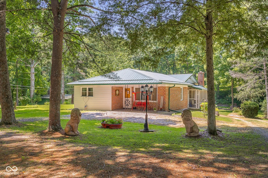 13052 S 600 E, Elizabethtown, IN 47232 - ranch-style home featuring a front lawn, a metal roof, brick siding, and driveway