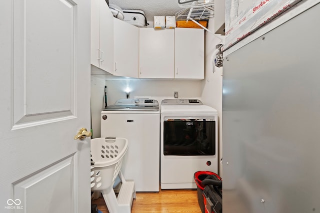 1044 Miller St, Clinton, IN 47842 - laundry room with washer and dryer, cabinet space, and light wood-style floors