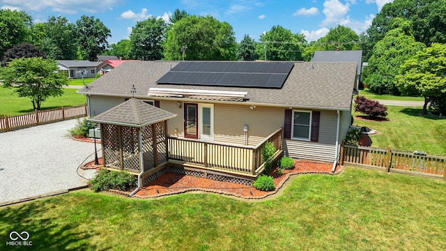1044 Miller St, Clinton, IN 47842 - rear view of property featuring solar panels, a shingled roof, a fenced backyard, and a deck
