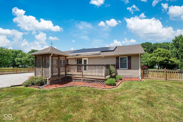 1044 Miller St, Clinton, IN 47842 - rear view of property with solar panels, a wooden deck, a fenced backyard, and a gazebo
