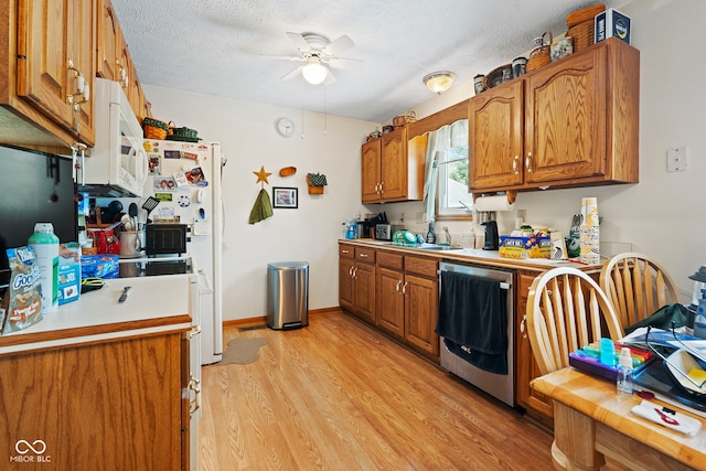 1044 Miller St, Clinton, IN 47842 - kitchen with dishwasher, white microwave, brown cabinetry, light wood finished floors, and a ceiling fan