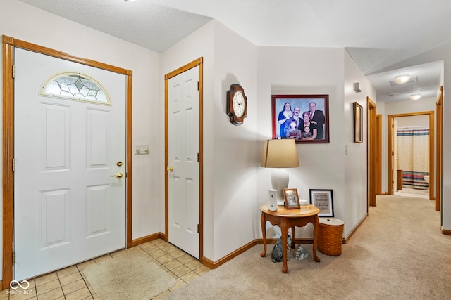 1044 Miller St, Clinton, IN 47842 - foyer entrance with light tile patterned floors and light colored carpet