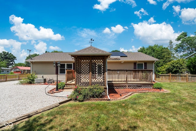 1044 Miller St, Clinton, IN 47842 - rear view of house featuring solar panels, a wooden deck, and roof with shingles