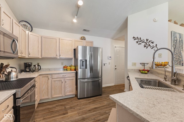7009 Thousand Oaks Ln, Indianapolis, IN 46214 - kitchen with appliances with stainless steel finishes, light brown cabinets, dark wood-style floors, and a textured ceiling