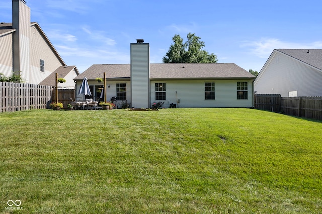 7009 Thousand Oaks Ln, Indianapolis, IN 46214 - back of property with a fenced backyard and a chimney