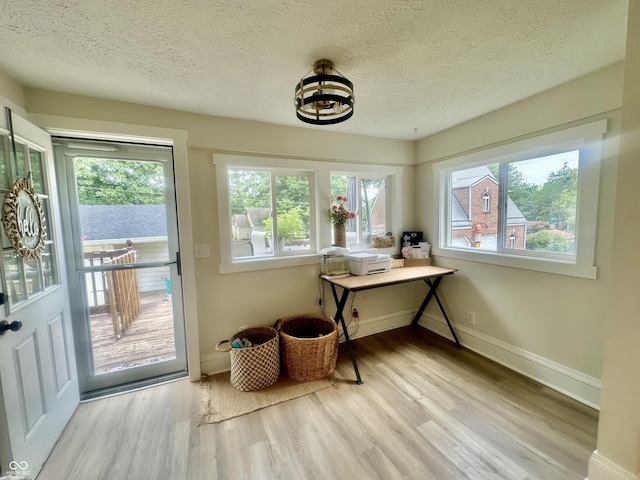 513 N Main St, Veedersburg, IN 47987 - entryway featuring wood finished floors, healthy amount of natural light, a textured ceiling, and a chandelier