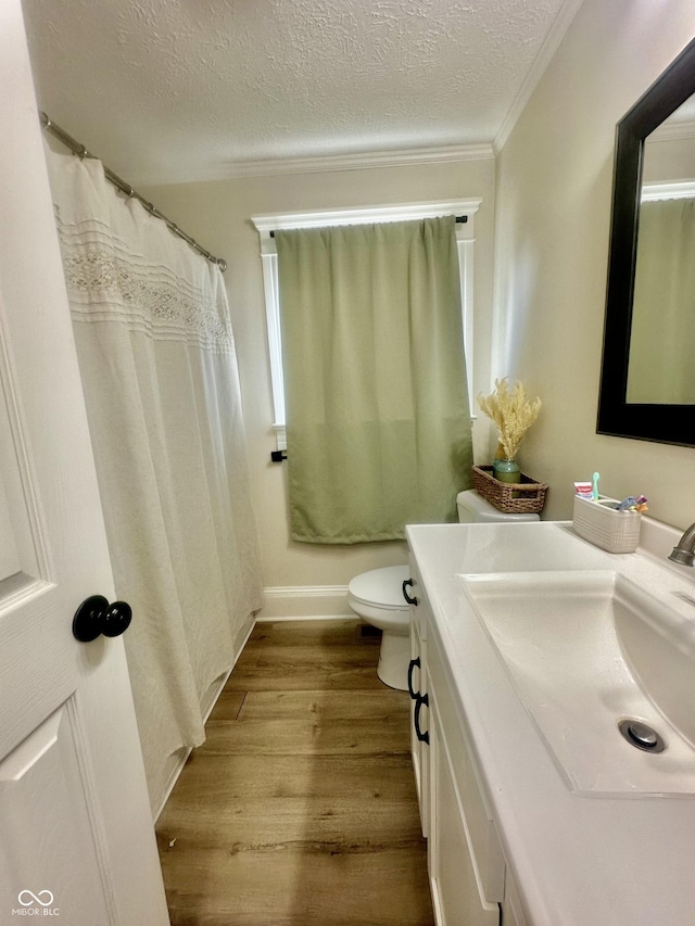 513 N Main St, Veedersburg, IN 47987 - full bathroom with vanity, wood finished floors, a textured ceiling, and ornamental molding