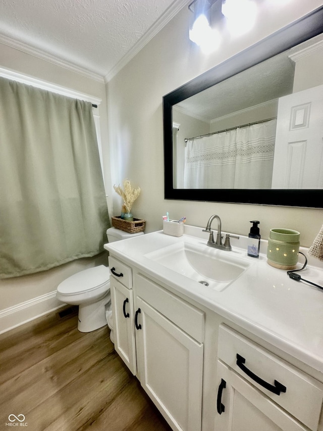 513 N Main St, Veedersburg, IN 47987 - full bathroom with wood finished floors, vanity, crown molding, and a textured ceiling