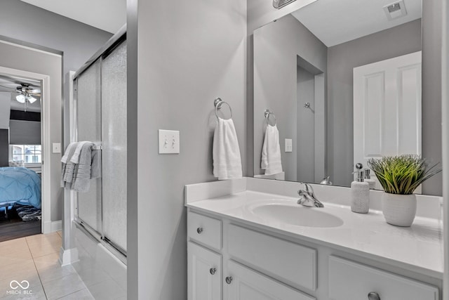 11354 Redwing Ct, Fishers, IN 46037 - bathroom featuring ensuite bathroom, vanity, ceiling fan, tile patterned floors, and combined bath / shower with glass door